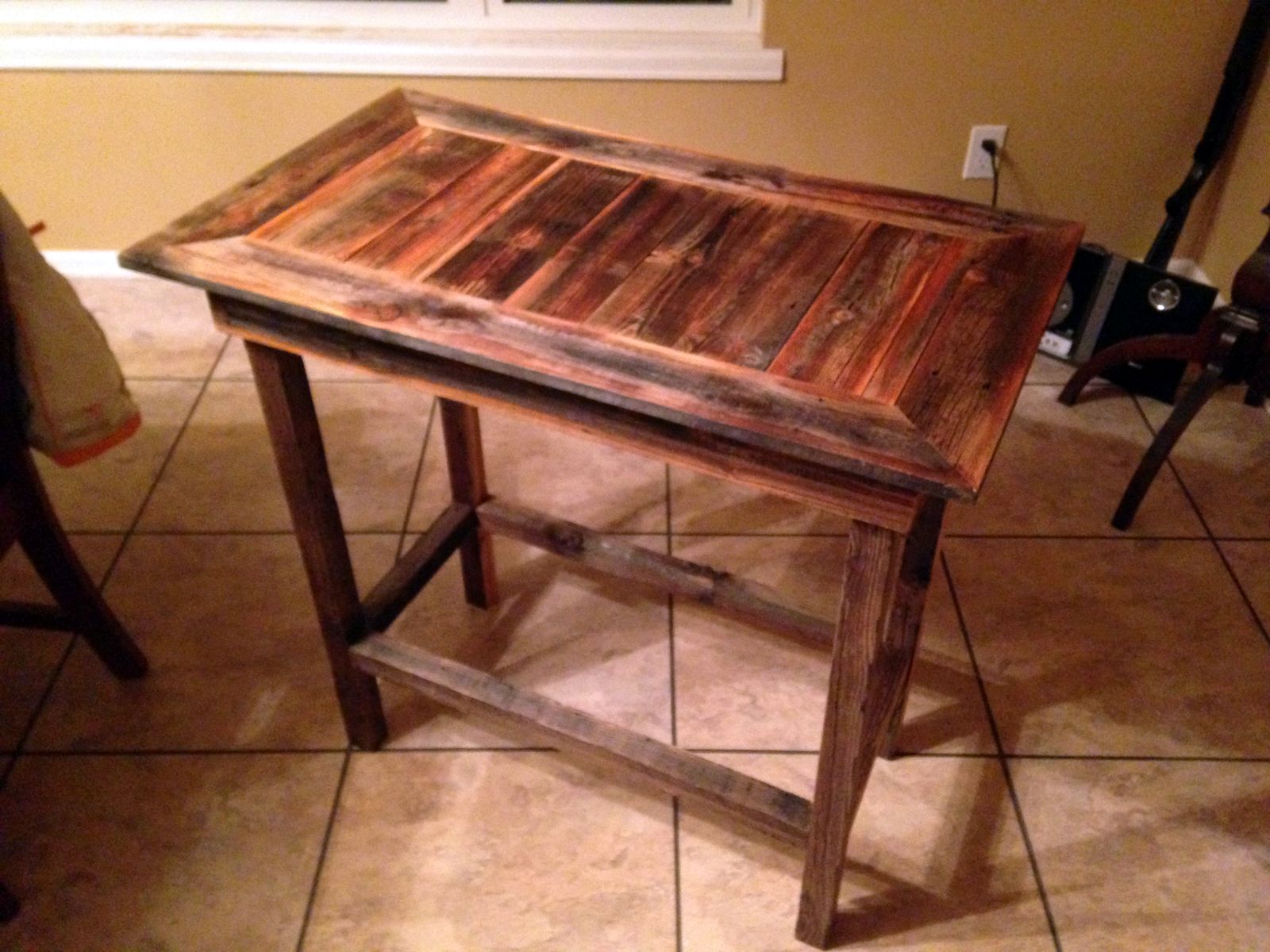 Reclaimed wood console table with a framed top and stretcher base