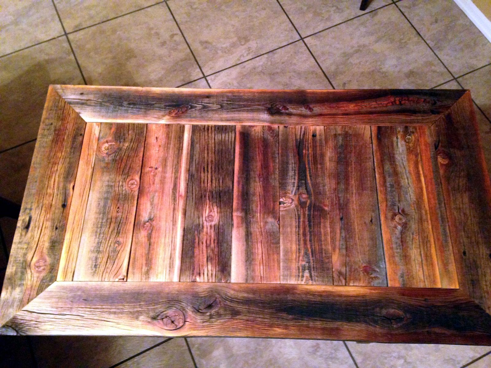 Close view of the console tabletop and its surrounding wood frame